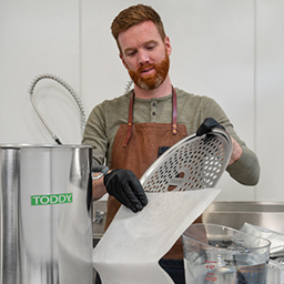 Barista inserting platform into Pro Series filter